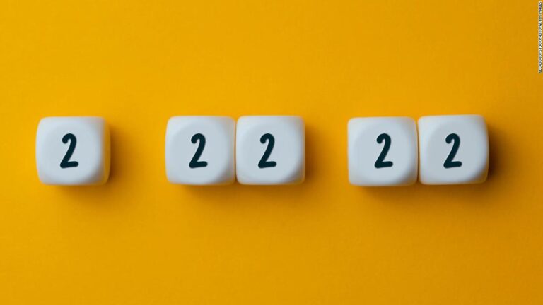 Numbers 2 22 22 on white cubes shapes on yellow background.