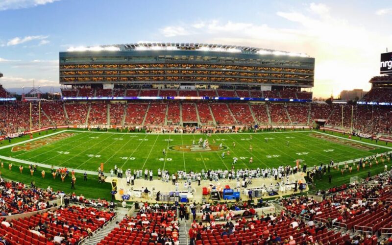 nfl stadium field full with crowd watching the game during daytime
