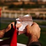 closeup of a man holding tickets on a ferry