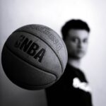 grayscale photo of man holding nba basketball