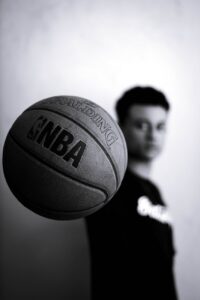 grayscale photo of man holding nba basketball