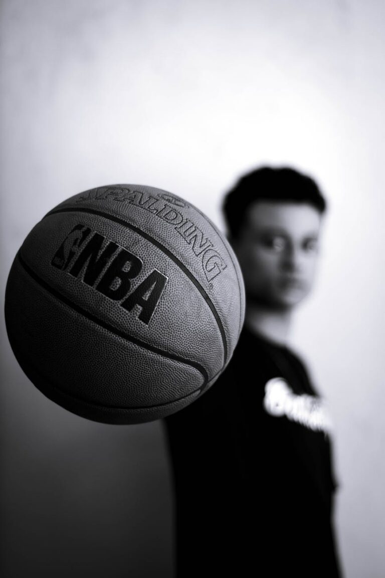 grayscale photo of man holding nba basketball