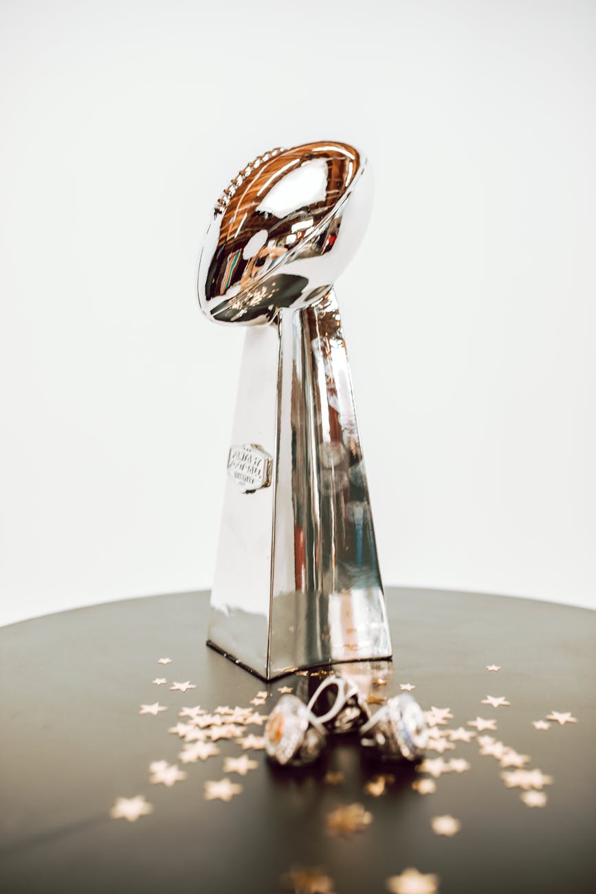 chrome trophy beside championship rings