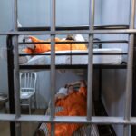 men in over clothing lying on the bunk bed