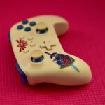 stylish gaming controller on pink background