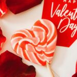 close up photo of lollipop and red petals